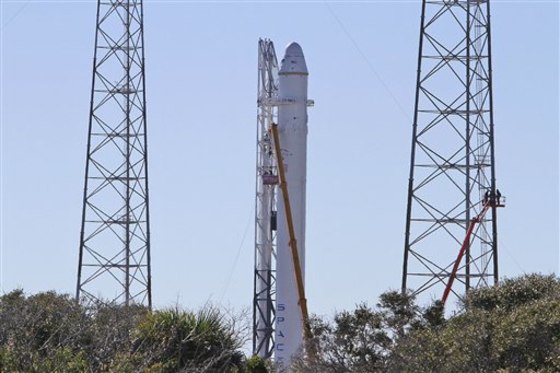 Workers at SpaceX continue to work on the Falcon 9 rocket Tuesday, Dec. 7, 2010 in Cape Canaveral, Fla. 